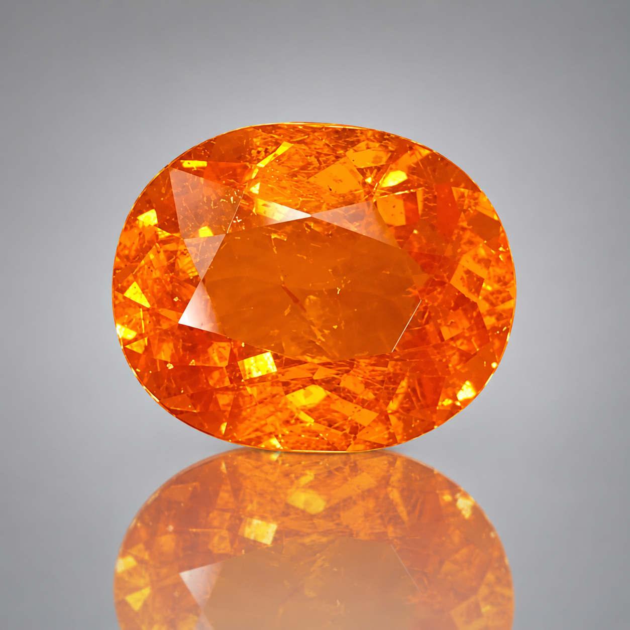 6.39 ct Fanta orange spessartite garnet, cushion modified brilliant, on white foam