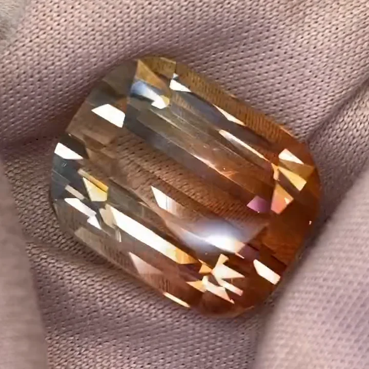 16.52 ct golden flame bicolor tourmaline, cushion fine step cut, on cloth