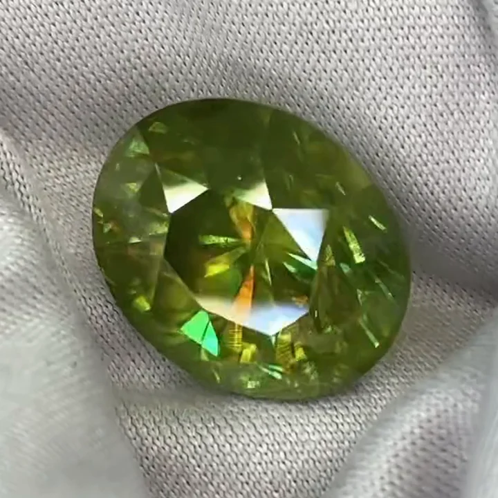 13.60 ct chrome green sphene, oval, on white cloth