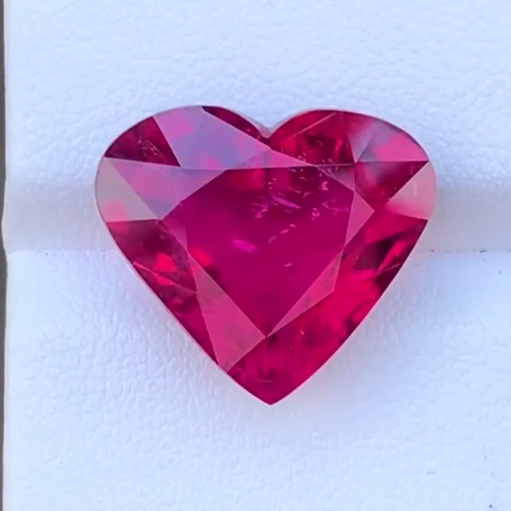 13.93 ct rubellite tourmaline heart, step cut, on a white card
