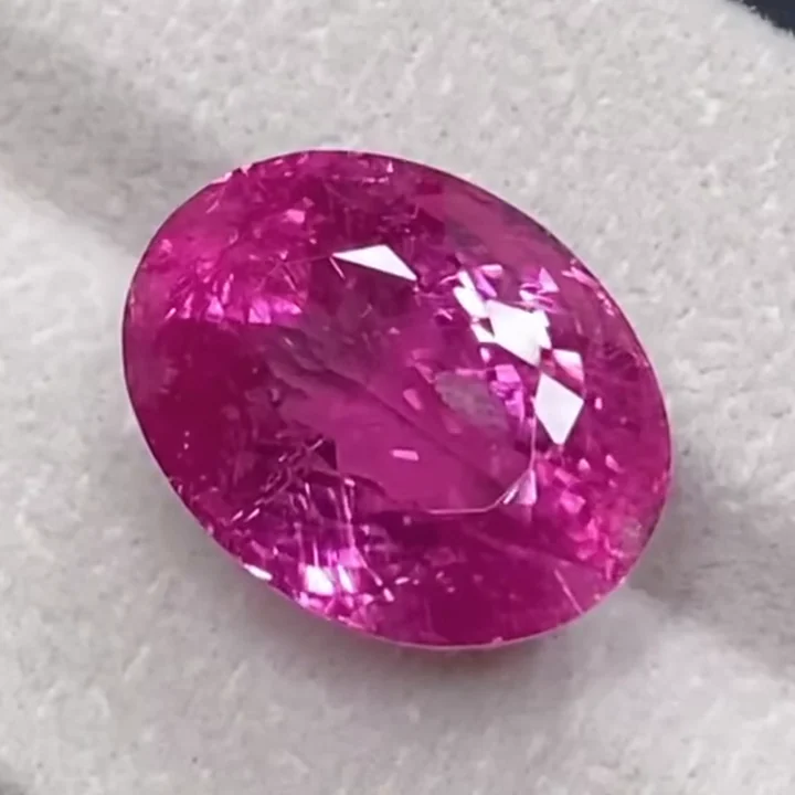 17.91 ct vibrant pink rubellite tourmaline, oval modified brilliant, on a pale card