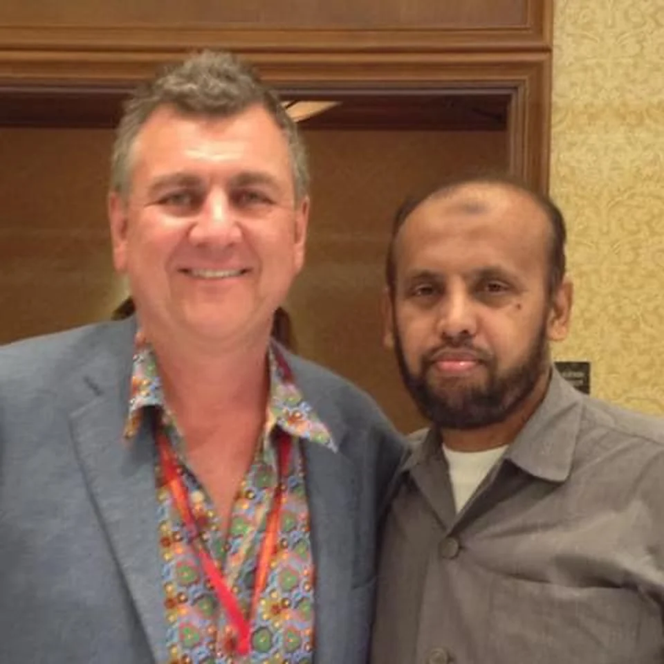 Mohamed Sirajudeen posing with another man indoors